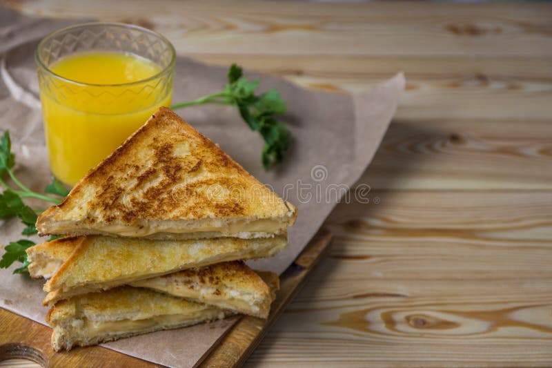 Cheese Toasts for Breakfast and Orange Juice in Glass. Sandwich Stock
