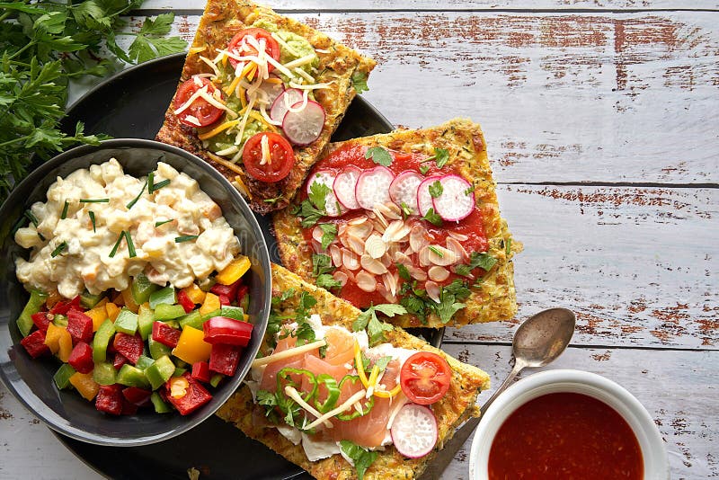 Cheese and zucchini tortillas, smoked salmon, raishes, cherry tomatoes, avocado cream, cream cheese, tomato cream with basil. stock photos Cheese and zucchini tortillas, smoked salmon, raishes, cherry tomatoes, avocado cream, cream cheese, tomato cream with basil. stock photos