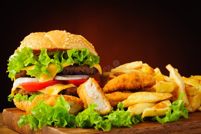 Cheeseburger, fried chicken nuggets and french fries stock photos Cheeseburger, fried chicken nuggets and french fries stock photos