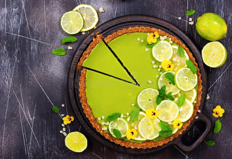 Cheesecake with slices of lime and lemon and fresh mint