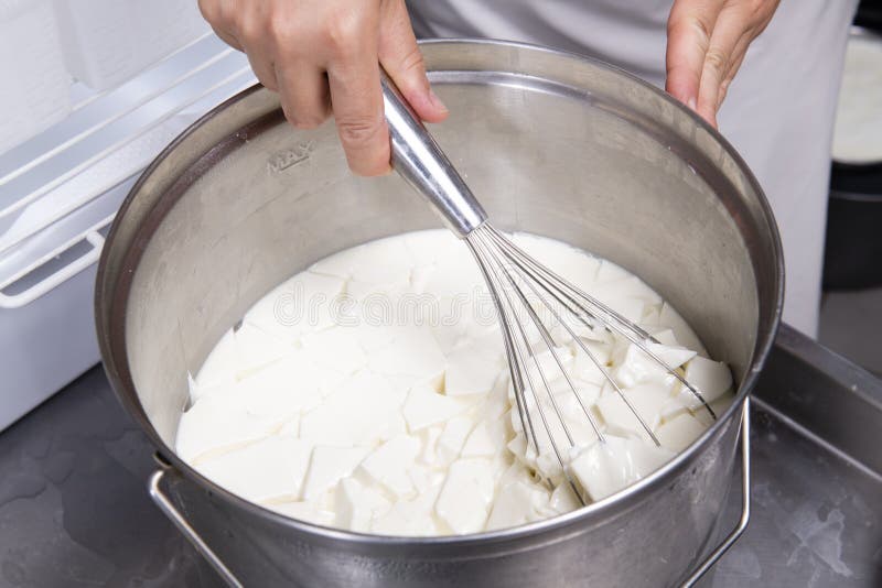 Cheesemaker Mixes Curdled Milk with a Whisk Stock Photo Image of hand