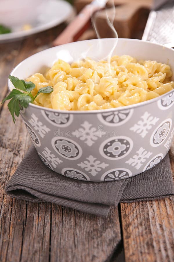 Cheesy Pasta with Cheese and Potato Chips in Glass Container Stock