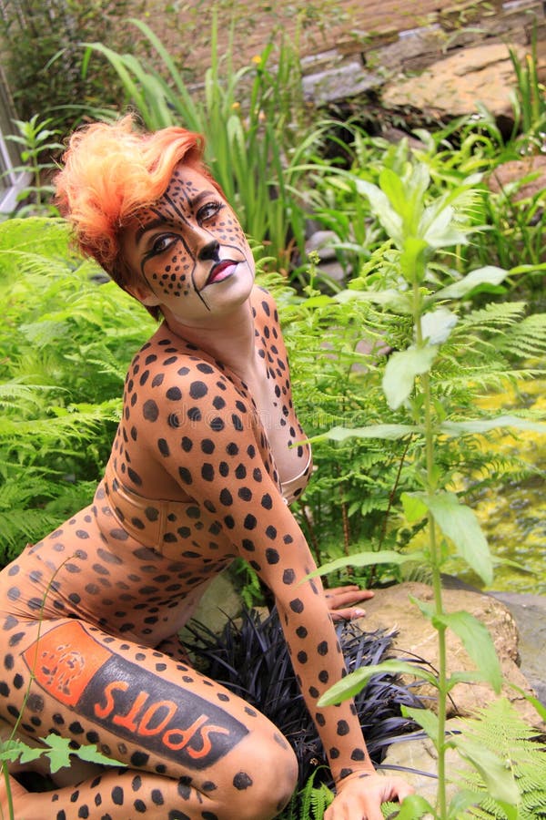 Cheetah bodypaint girl in garden. 