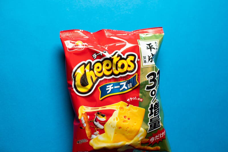 Cheetos cheese flavor chips. Cheetos formerly styled as Chee-tos until 1998 is brand of cheese-flavored puffed cornmeal snacks made by Frito-Lay, subsidiary of royalty free stock photography Cheetos cheese flavor chips. Cheetos formerly styled as Chee-tos until 1998 is brand of cheese-flavored puffed cornmeal snacks made by Frito-Lay, subsidiary of royalty free stock photography
