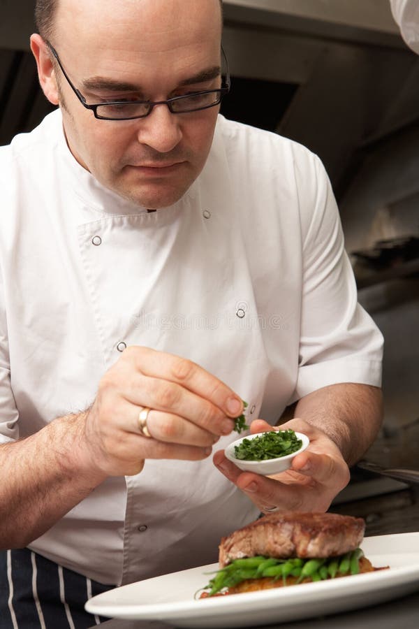 Chef Adding Sauce To Dish in Restaurant Kitchen Stock Photo Image of