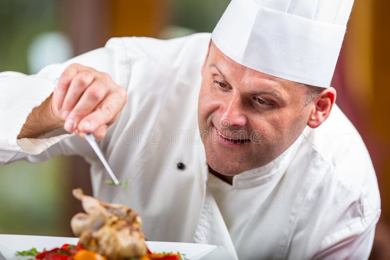 Chef. Chef cooking.Chef decorating dish. Chef preparing a meal. Chef in hotel or restaurant kitchen prepares decorating dish with stock image Chef. Chef cooking.Chef decorating dish. Chef preparing a meal. Chef in hotel or restaurant kitchen prepares decorating dish with stock image