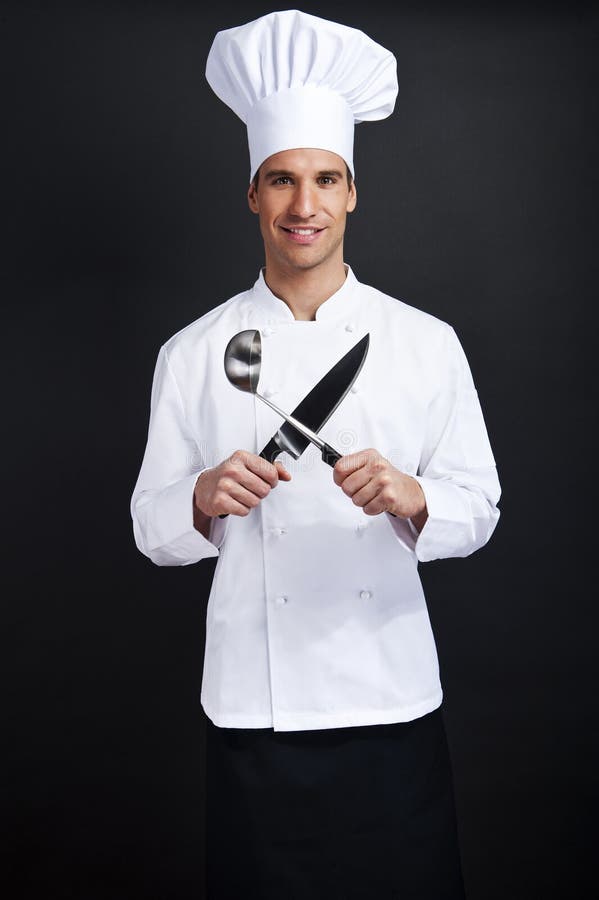 Chef cook against dark background smiling