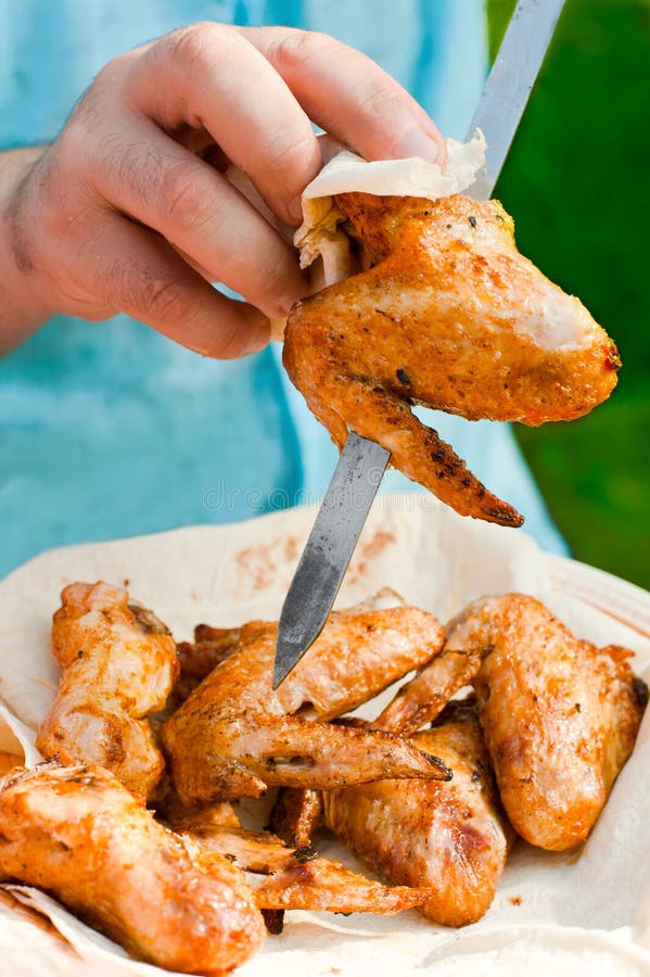 Chef cook preparing grilled chicken wings