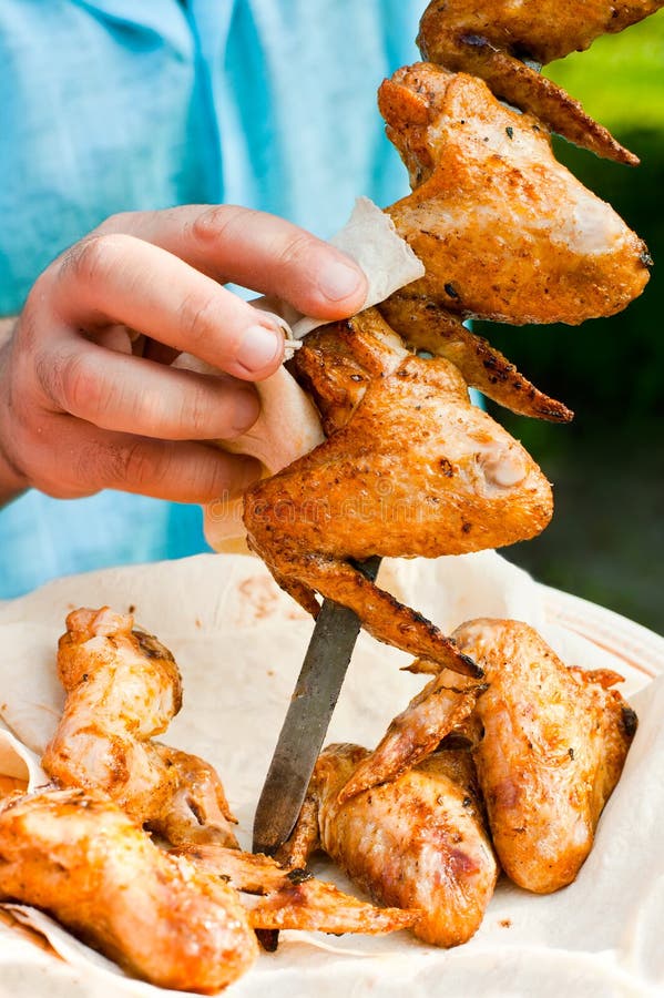 Chef cook preparing grilled chicken wings