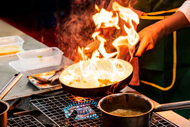 Chef Cooking with Flame in a Frying Pan on a Kitchen Stove Stock Photo Image of frying, tasty