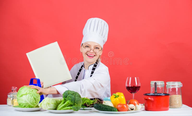 Chef cooking healthy food. Girl read book best culinary recipes. Culinary school concept. Book by famous chef copy space.