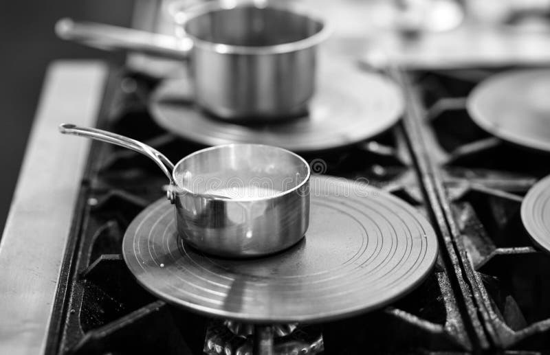 Chef Cooking in a Kitchen, Chef at Work, Black and White Stock Photo