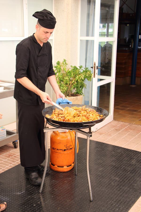 Chef cooking paella editorial stock photo. Image of crab 56402298