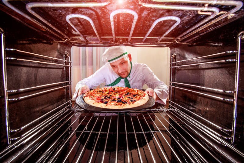 Chef Cooking Pizza In The Oven. Stock Photo Image of