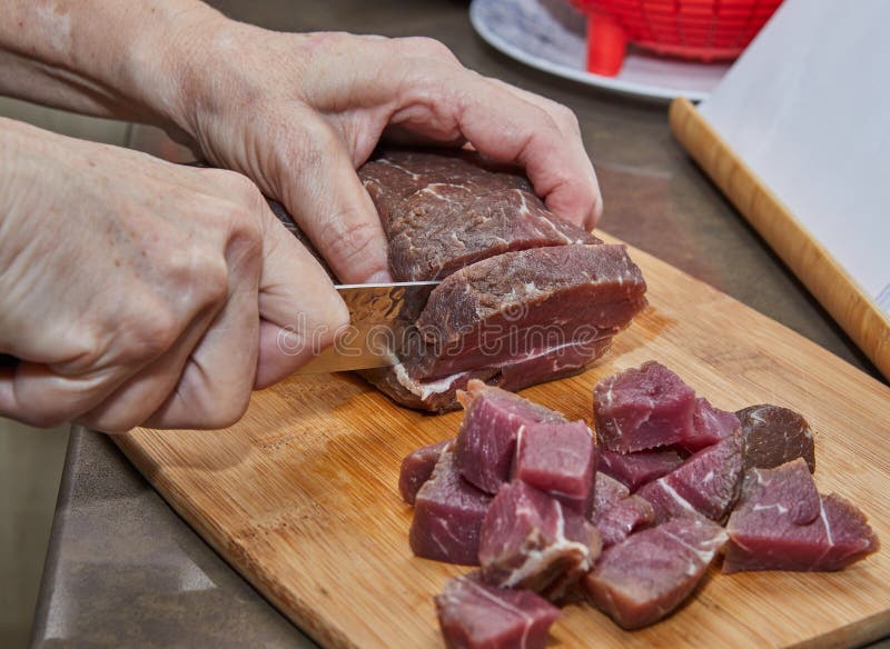 Chef Cuts the Beef Meat into Cubes for Cooking Stock Photo Image of