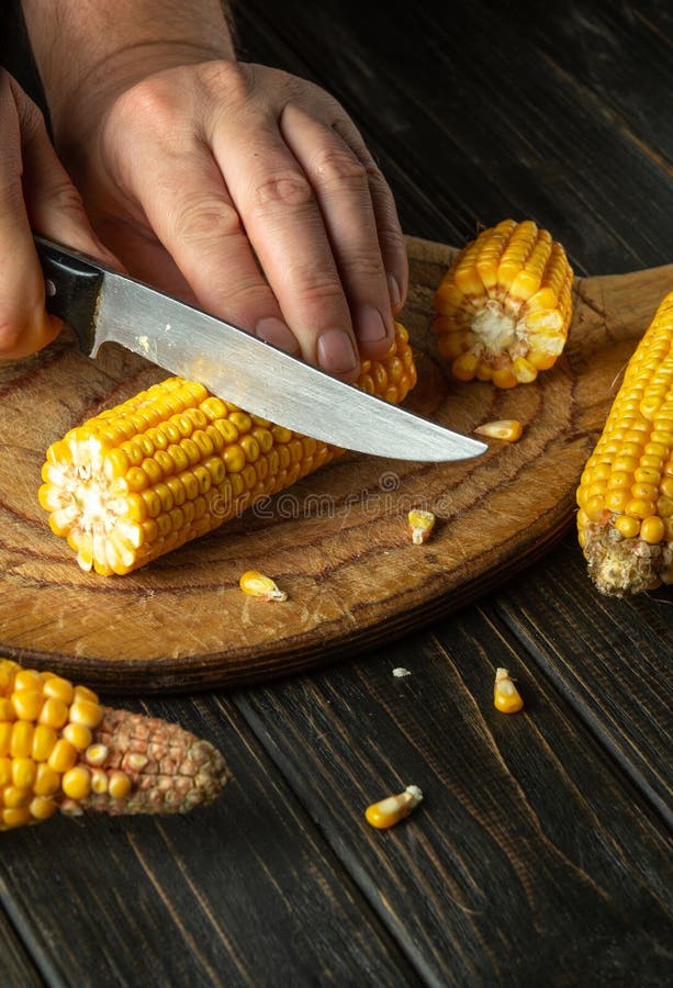 The Chef Cuts the Maize with a Knife. Corn is an Excellent Dietary