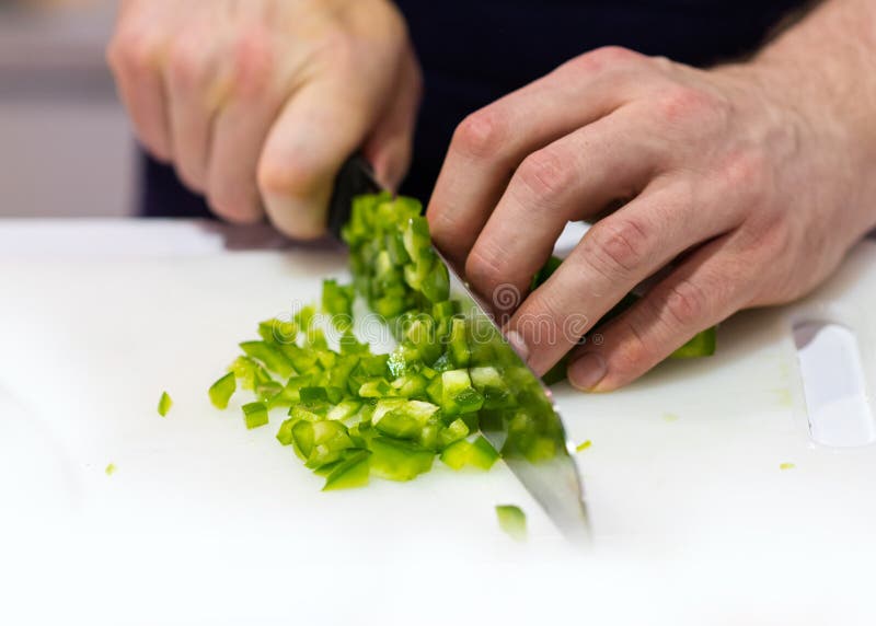Chef Cuts the Vegetables Cooking in a Kitchen, Hands Slicing Vegetables