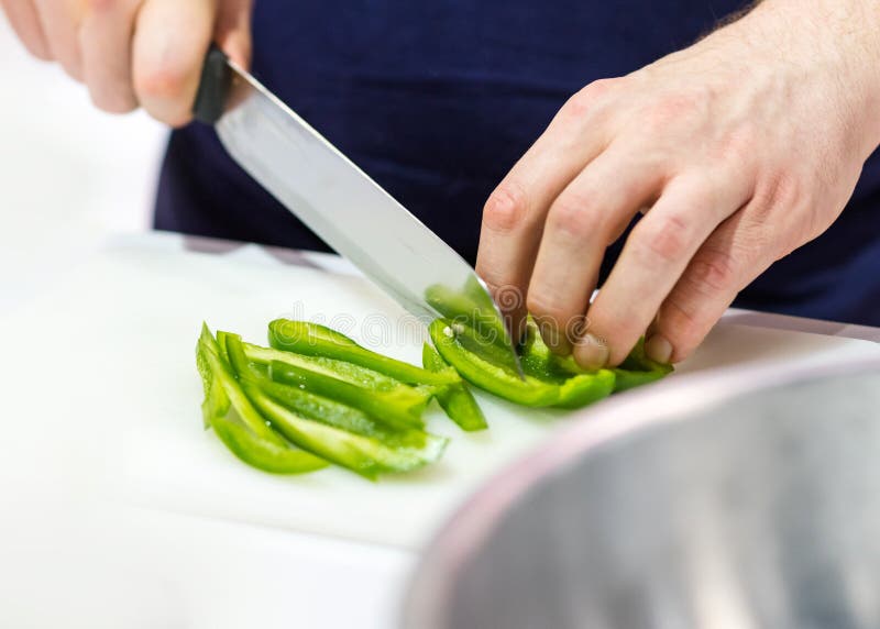 Chef Cuts the Vegetables Cooking in a Kitchen, Hands Slicing Vegetables