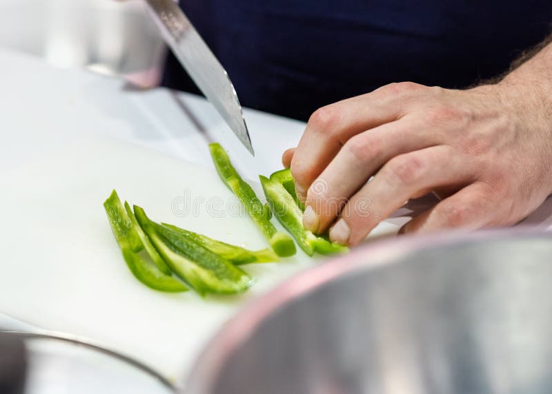 Chef Cuts the Vegetables Cooking in a Kitchen, Hands Slicing Vegetables
