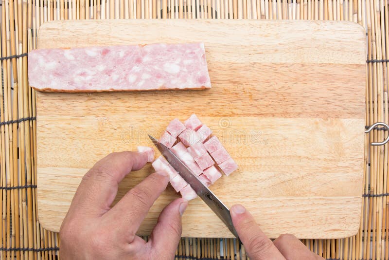 Chef cutting bacon for cooking fired rice