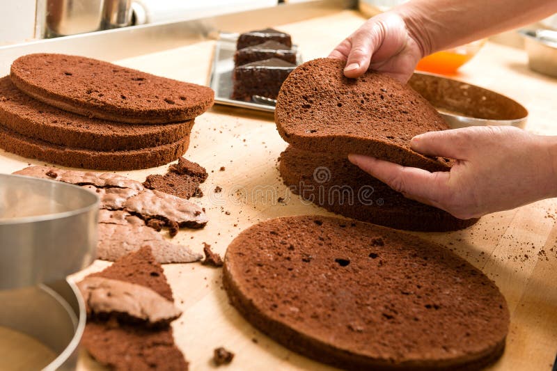 Chef cutting cake layers and stacking them