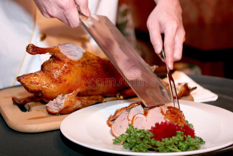 Chef cutting duck Chinese restaurant