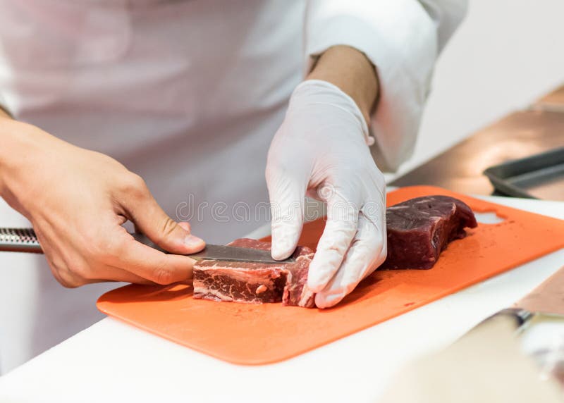 Chef Cutting Fresh Raw Meat with Knife in the Kitchen, Chef Cutting