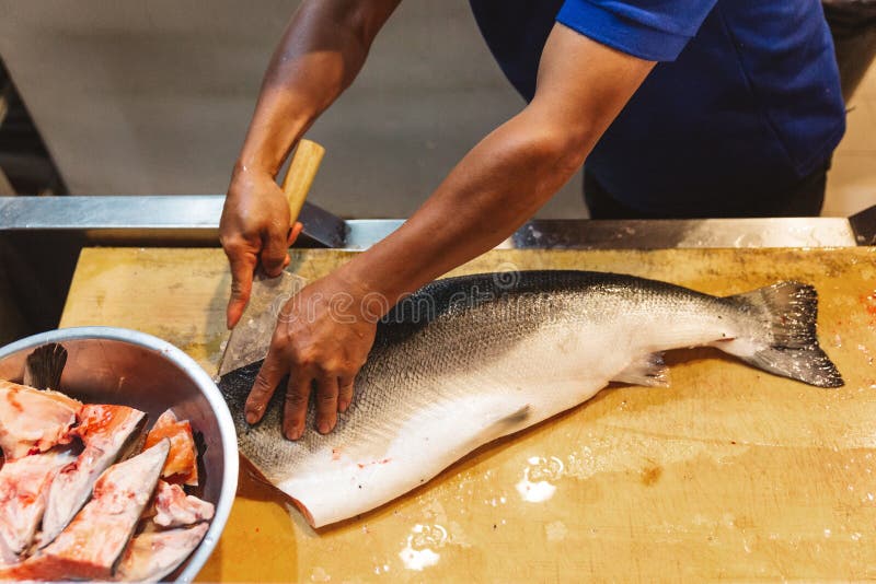 Chef Cutting Fresh Salmon and Separate Parts for Making Sushi and