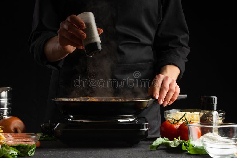 Chef fries vegetables with meat for cooking a delicious dish. Peppers. Restaurant business and fast food. Gastronomy and cooking. royalty free stock photo Chef fries vegetables with meat for cooking a delicious dish. Peppers. Restaurant business and fast food. Gastronomy and cooking. royalty free stock photo