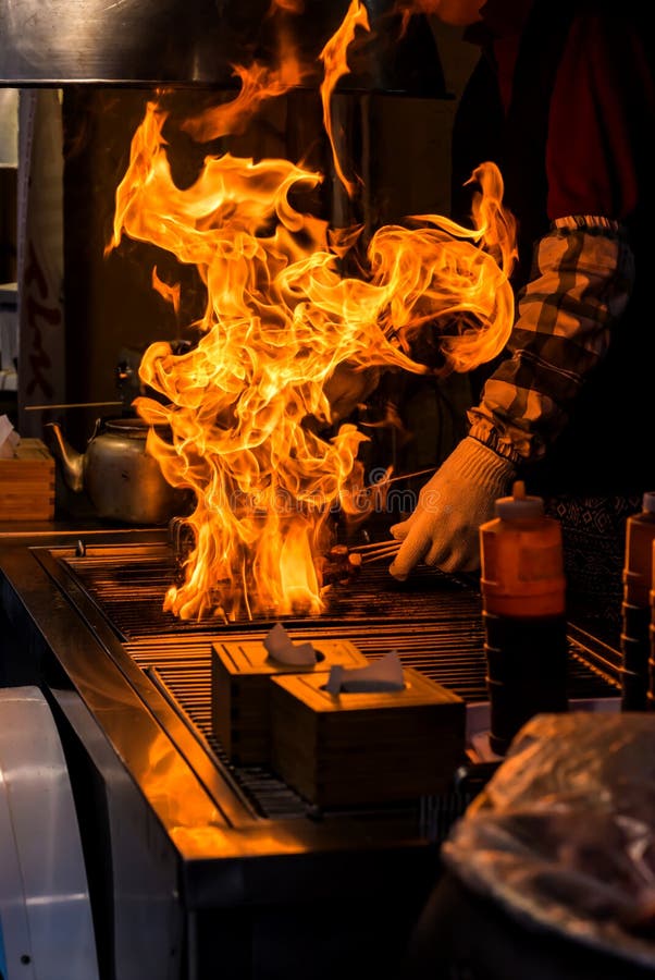 Chef Grilling Bbq with Flame of Burning in Restaurant Stock Photo