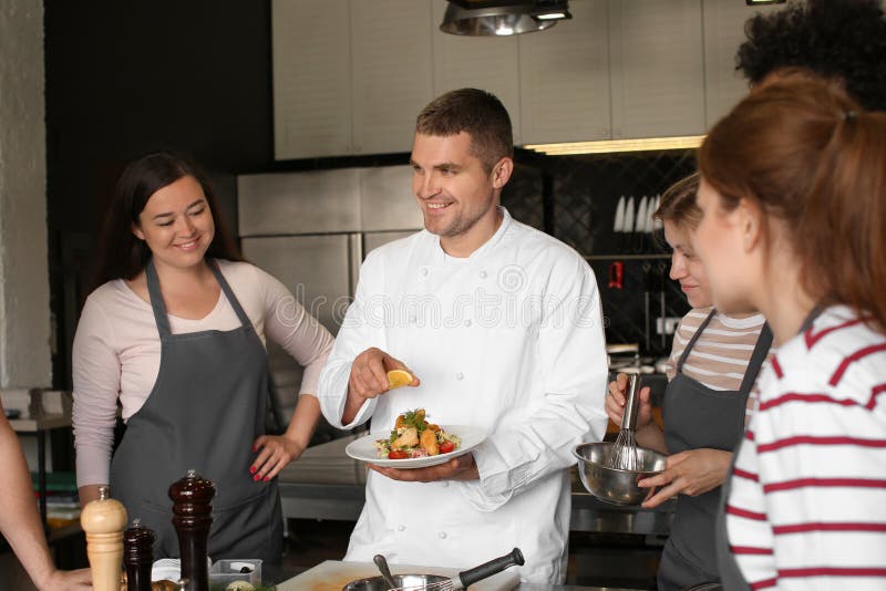 Chef and Group of Young People during Cooking Classes Stock Image