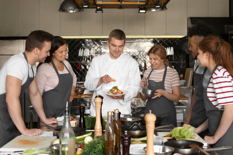 Chef and Group of Young People during Cooking Classes Stock Photo