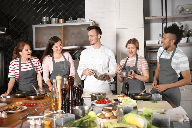 Chef and Group of Young People during Cooking Classes Stock Image