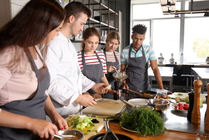Chef and Group of Young People during Cooking Classes Stock Photo
