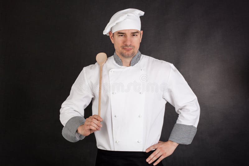 Chef holding wooden spoon stock photo. Image of ladle 40367026