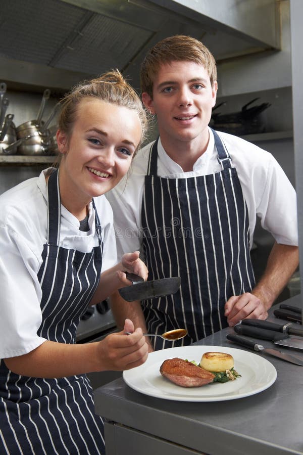 Chef Instructing Trainee in Restaurant Kitchen Stock Photo - Image of