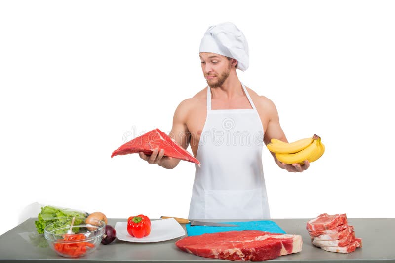 Chef-kok in een wit vlees en de bananen van de schortholding royalty-vrije stock foto's Chef-kok in een wit vlees en de bananen van de schortholding royalty-vrije stock foto's