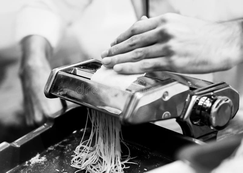 Chef Making Pasta with a Machine, Home Made Fresh Pasta Stock Photo