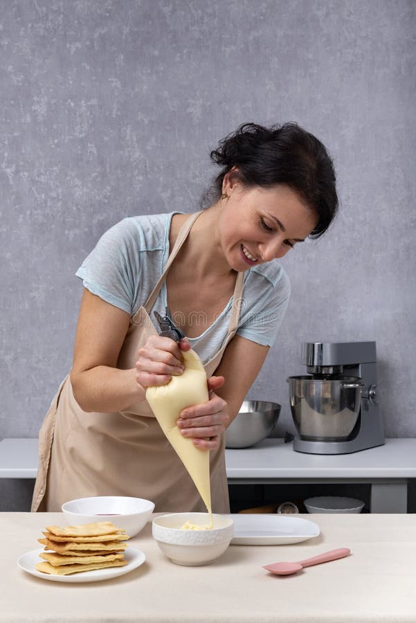 Women Pastry Chef Prepares Cake from Shortcakes and Cream. Process of