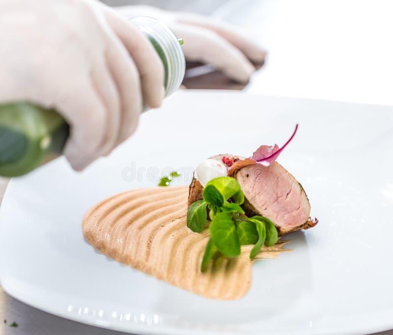 Chef pouring sauce royalty free stock photos