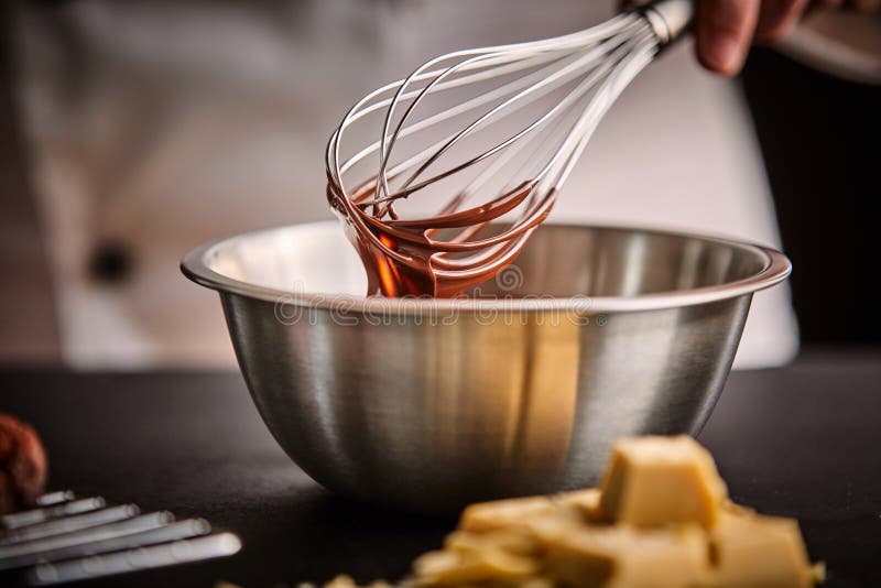 Chef preparing melted chocolate in a mixing bowl stock images Chef preparing melted chocolate in a mixing bowl stock images