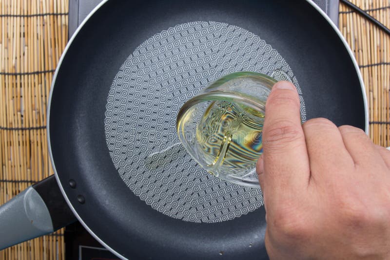 Chef putting oil to pan stock image. Image of vegetable 75957569