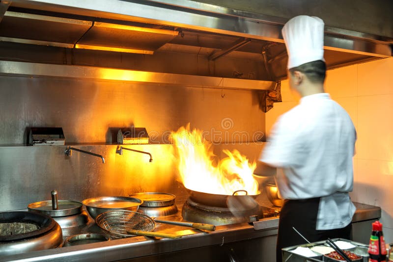 Chef in Restaurant Kitchen at Stove with Pan Stock Photo Image of