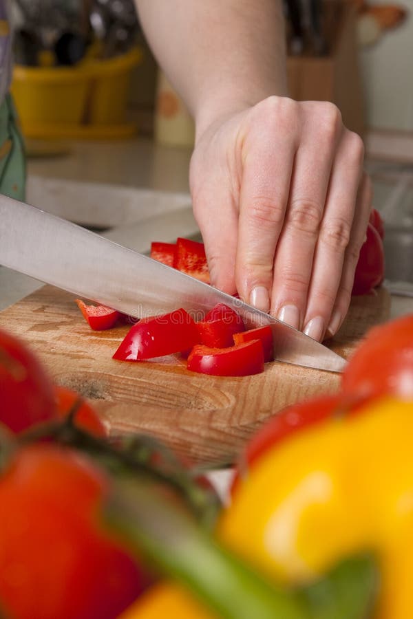 Chef s hands cutting vegetables.