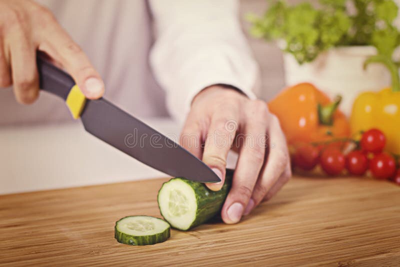 Chef`s Hands. Man is Ready To Prepare Fresh Salad. Chopping Cucumber ...