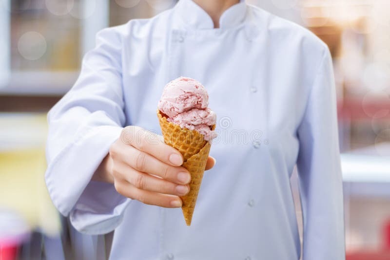 Chef shows an ice cream cone. royalty free stock photography