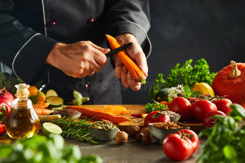 Chef slicing fresh carrots for a salad