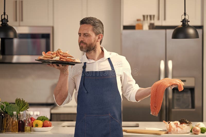 Chef Smell Lobster and Salmon Seafood in the Kitchen Stock Photo