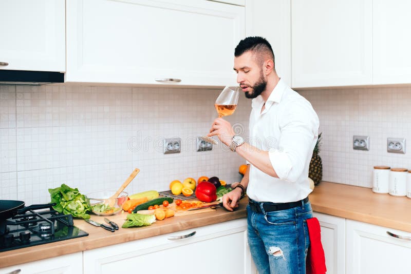 Chef Tasting Rose Wine, Perfect Match for Salad in Modern Kitchen Stock