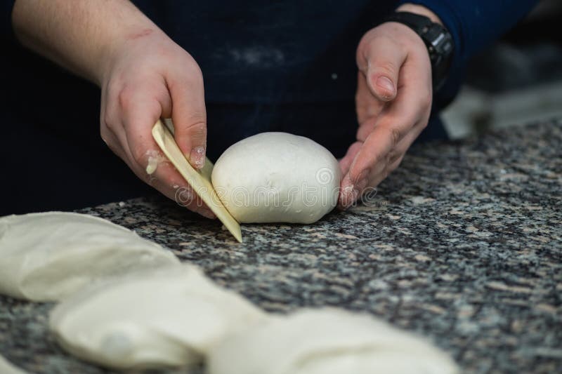 Chefs Hand Preparing Dough for Pizza in Restaurant Kitchen Stock Photo